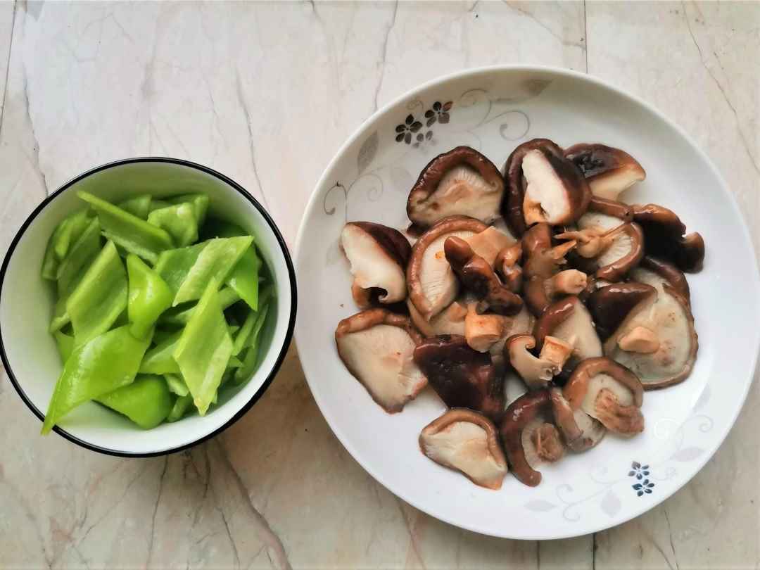 Cut the shiitake mushrooms in half and slice the green peppers.