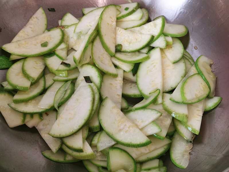 Pour in zucchini slices and stir-fry until soft